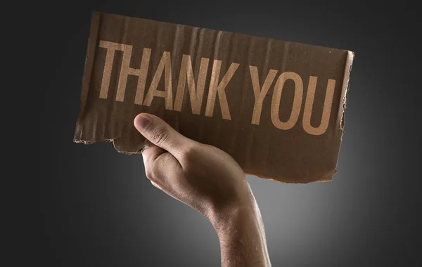 Hand holding cardboard with sign — Stock Photo, Image