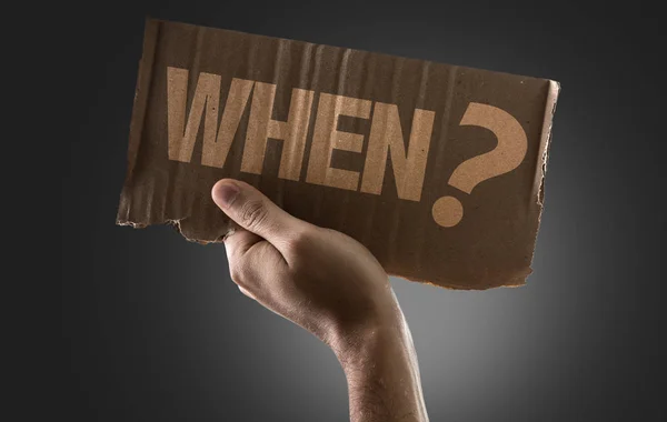 Cardboard with sign When? — Stock Photo, Image