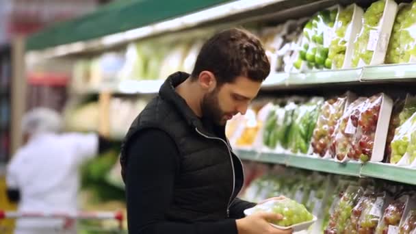 Молодой человек покупки в супермаркете — стоковое видео