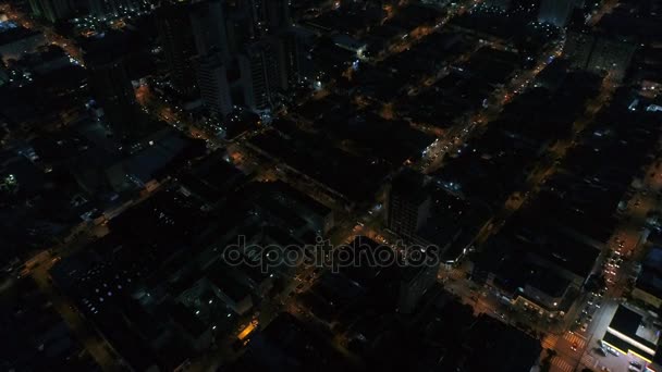 Bovenaanzicht van kruising, daken en verlichte straten — Stockvideo