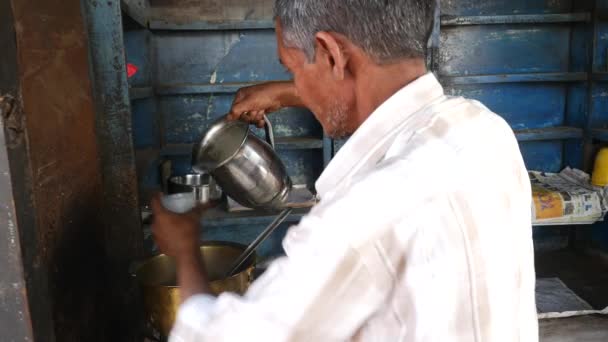 Man förbereder chai från sin butik längs gatan i Jaipur, India — Stockvideo