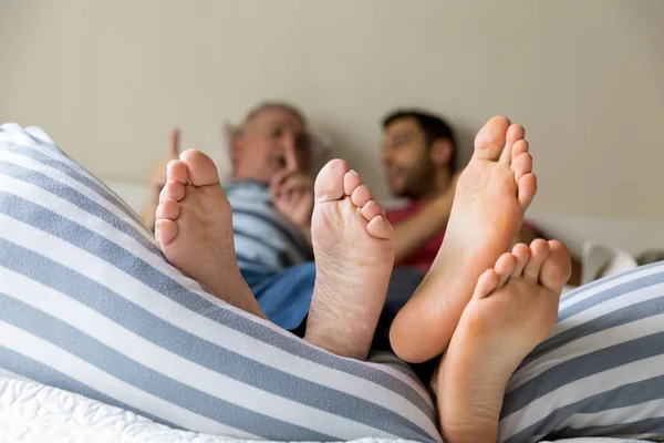Feet of Friends/Father and Son playing on the bed