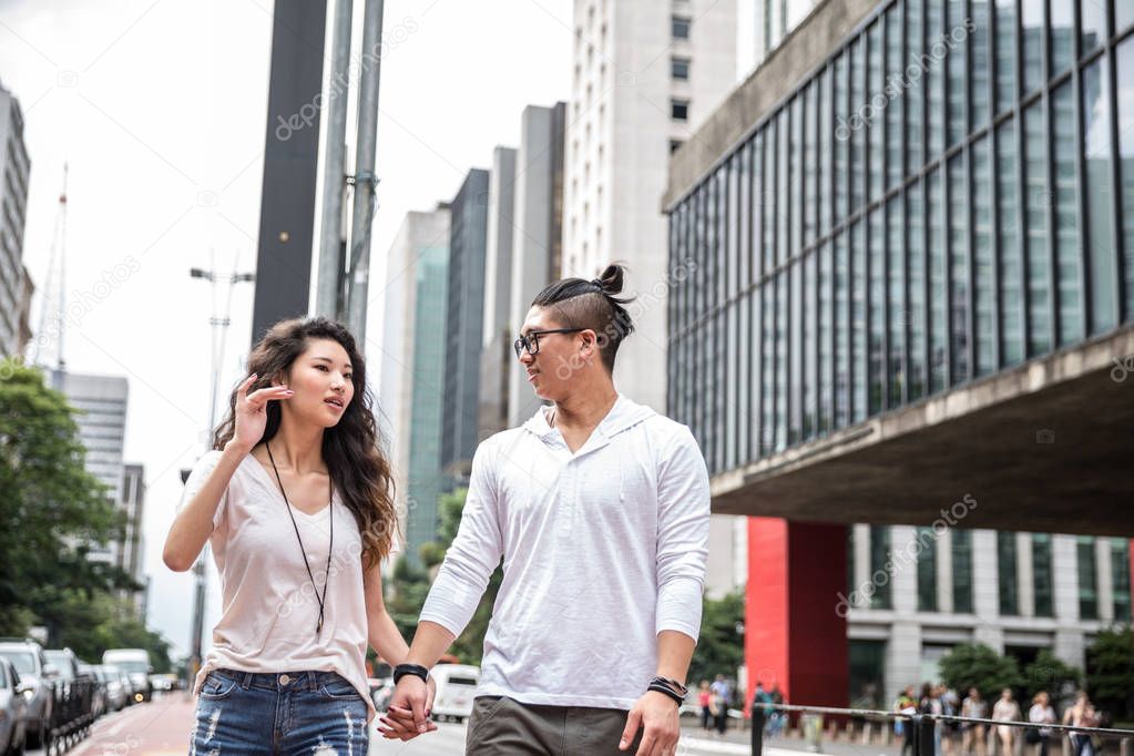 Young Asian Couple Tourist in Paulista Avenue, Sao Paulo, Brazil