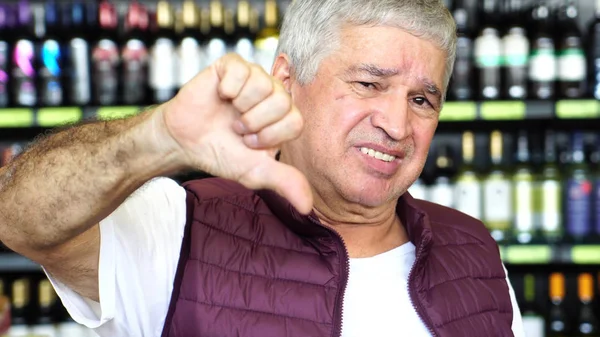 Mann Drückt Daumen Nach Unten Unzufrieden Mit Flaschen Hintergrund — Stockfoto