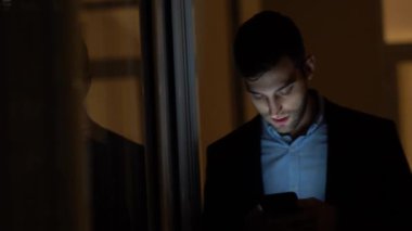 Yalnız karanlık ofisinde telefon kullanarak iş adamı