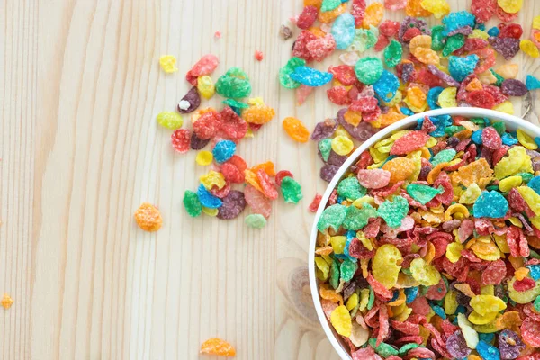 Kids healthy quick breakfast. Colorful rice cereal on wooden