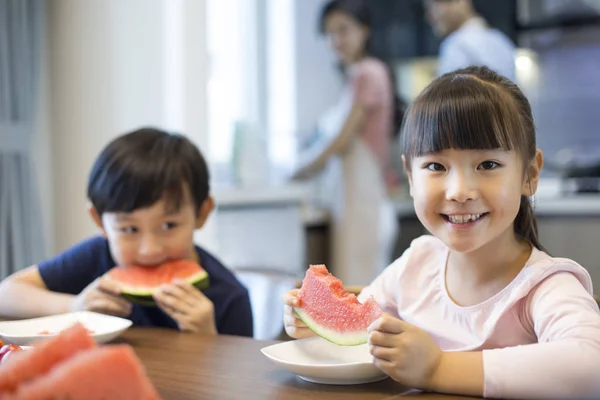Chinese Siblings Eating Watermelon Kitchen Tableac — Stock Photo, Image