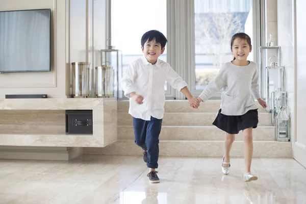 Chinese Siblings Holding Hands Running Living Room — Stock Photo, Image