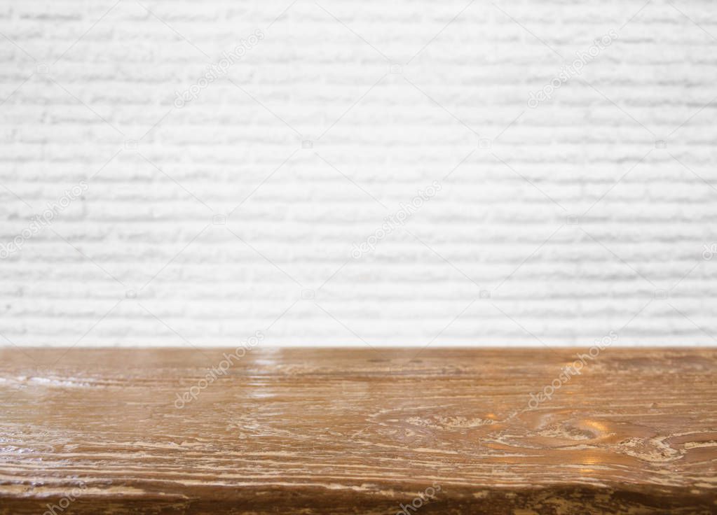 Empty wood table top with blurred white brick wall background, ready for product,motage