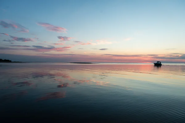 Riflessioni nella calma acqua del lago con piccola barca — Foto Stock