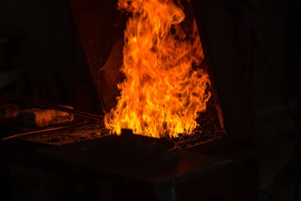 The blacksmith making flames in smithy — Stock Photo, Image