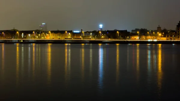 Summer night city light reflections over water — Stock Photo, Image