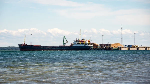 Cargo ship is leaving port sailing away — Stock Photo, Image