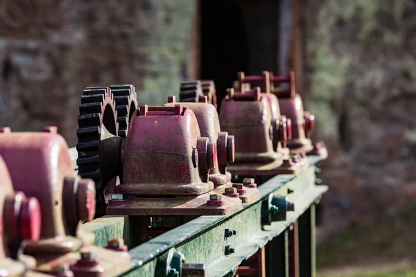 Old gears and cogs against blurred background