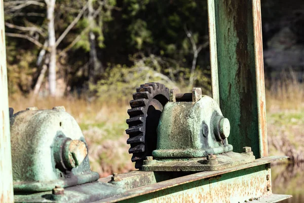 Old gears and cogs against blurred background