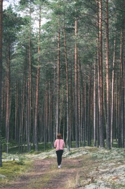 young woman enjoying nature in forest - vintage old look clipart