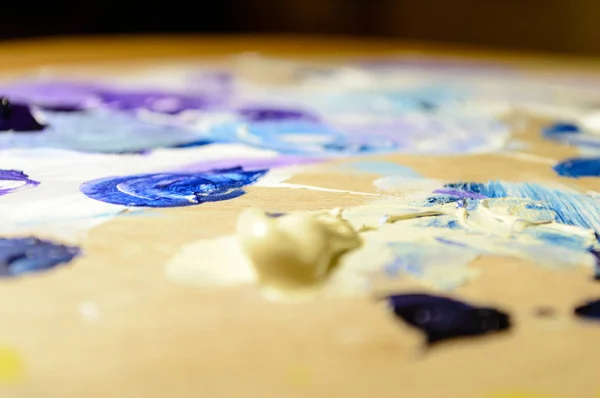 Artist painting with acrylic colors and mixing tones — Stock Photo, Image