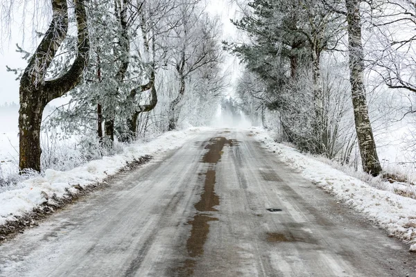 Car tire tracks on winter road — Stock Photo, Image