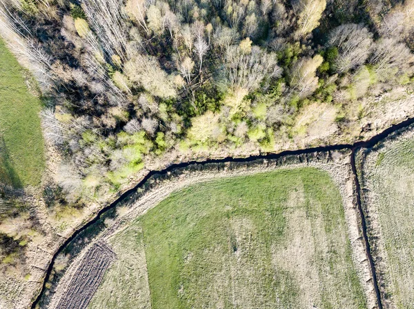 drone image. aerial view of rural area with wawy river ion fores