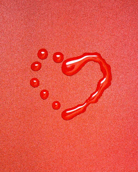 Heart from water drops on a red background