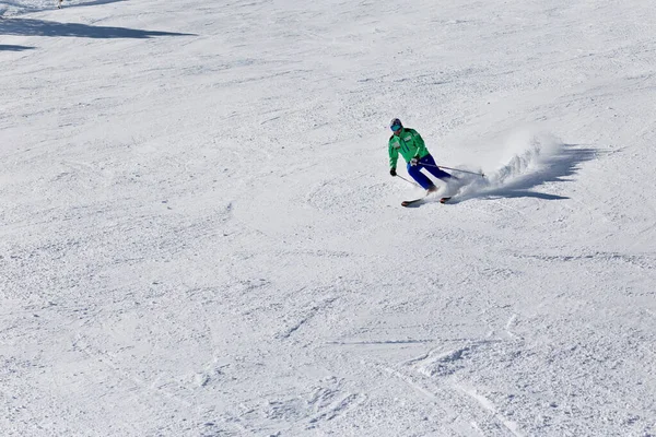 PYRENEES, ANDORRA - FEBRUARY 16, 2019: A skier descends from the mountain at high speed at a ski resort — ストック写真