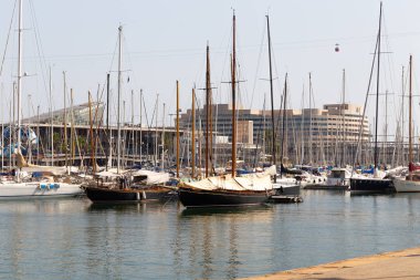 BARSELONA, SPAIN - AUGUST 6, 2019: Yachts parked in the port of Barcelona at summer noon.