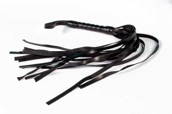 Black leather BDSM lash on white background