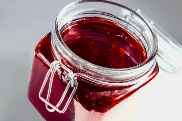 Art concept of Jam and glass jar strawberry jelly closeup view