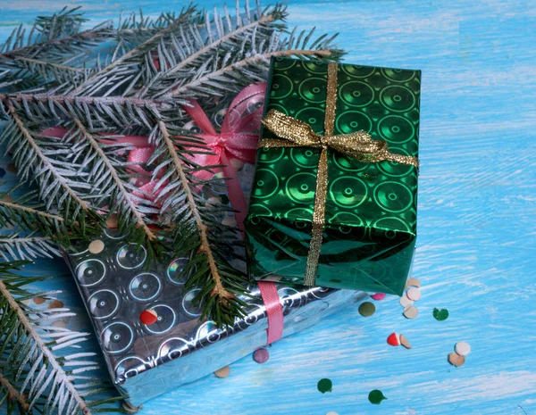 Wrapped in paper Christmas gifts and green fir branch on a light background Royalty Free Stock Images