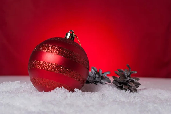 Christmas bollar och koner på en röd bakgrund — Stockfoto