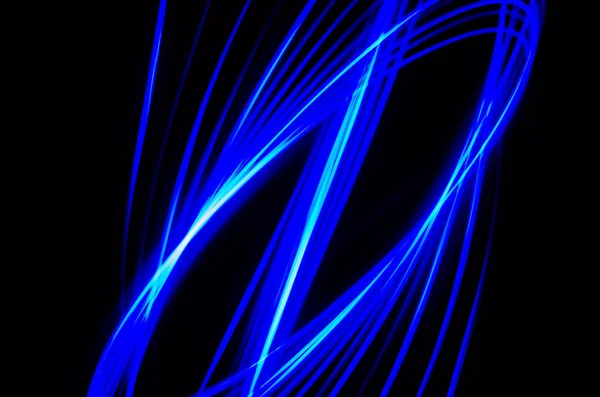 Light spiral and blue lines on a black background — Stock Photo, Image