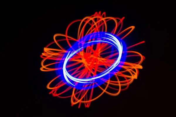 Light spiral, red and blue lines on a black background — Stock Photo, Image