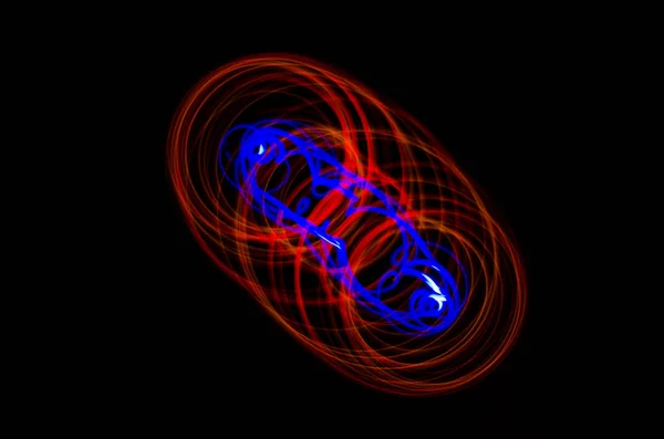 Light spiral, red and blue lines on a black background — Stock Photo, Image