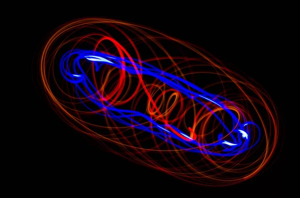 Light spiral, red and blue lines on a black background — Stock Photo, Image