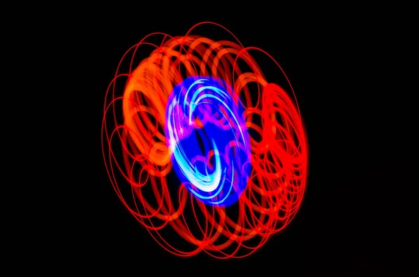 Light spiral, red and blue lines on a black background — Stock Photo, Image