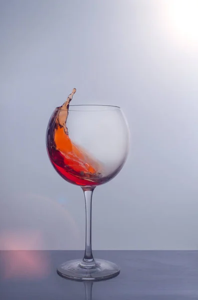 Splash of red wine in a glass — стоковое фото