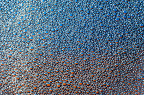 Les bulles de mousse sur fond bleu rouge texture — Photo