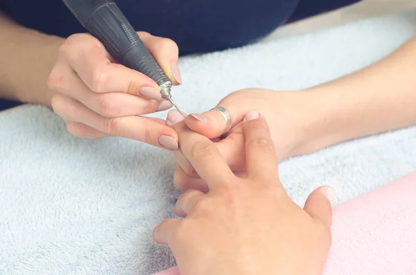 The master prepares the nails for manicure using the machine for manicure — Stock Photo, Image