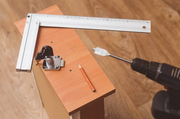 Installation mortise lock in the bedside table — Stock Photo, Image