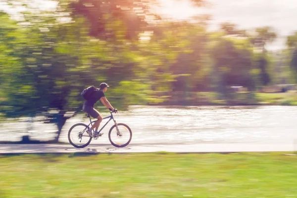 The cyclist in motion riding bicycle road, motion blur — Stock Photo, Image