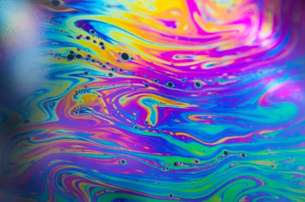 Beautiful psychedelic abstraction formed by light on the surface of a soap bubble