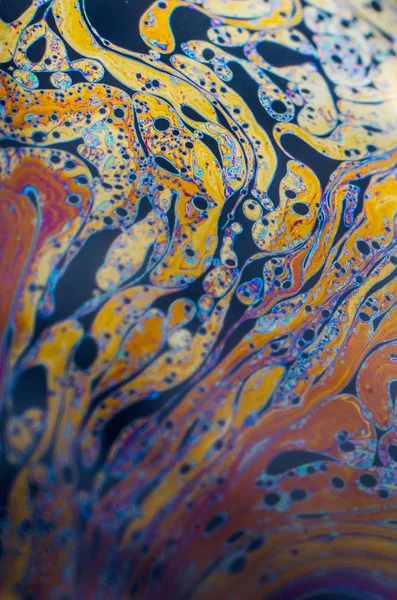 Beautiful psychedelic abstraction formed by light on the surface of a soap bubble