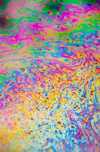 Beautiful psychedelic abstraction formed by light on the surface of a soap bubble