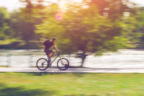 The cyclist in motion riding bicycle road, motion blur — Stock Photo, Image