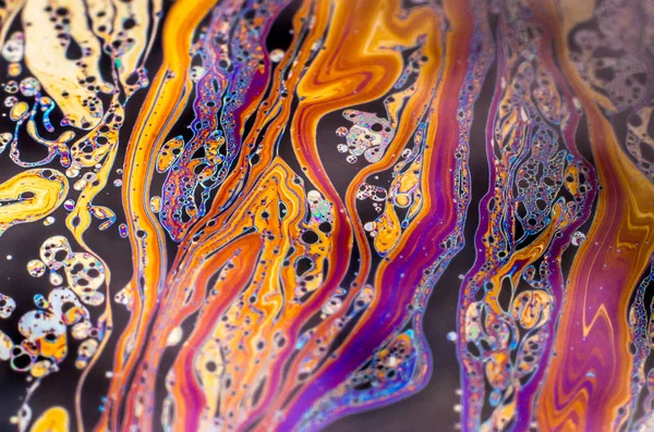 Beautiful psychedelic abstraction formed by light on the surface of a soap bubble
