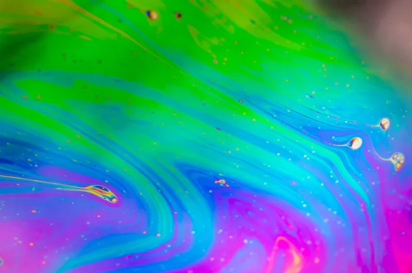 Beautiful psychedelic abstraction formed by light on the surface of a soap bubble