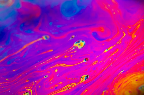 Beautiful psychedelic abstraction formed by light on the surface of a soap bubble