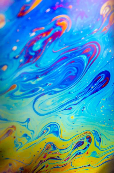 Beautiful psychedelic abstraction formed by light on the surface of a soap bubble