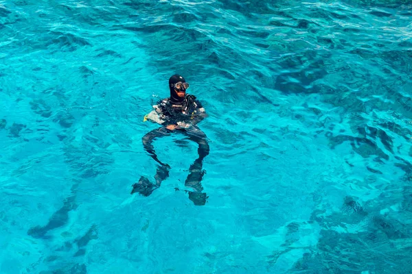 Sharm El Sheikh, Egipto, 8 de mayo de 2019: Un hombre en equipo de buceo nada en el agua azul clara del mar —  Fotos de Stock