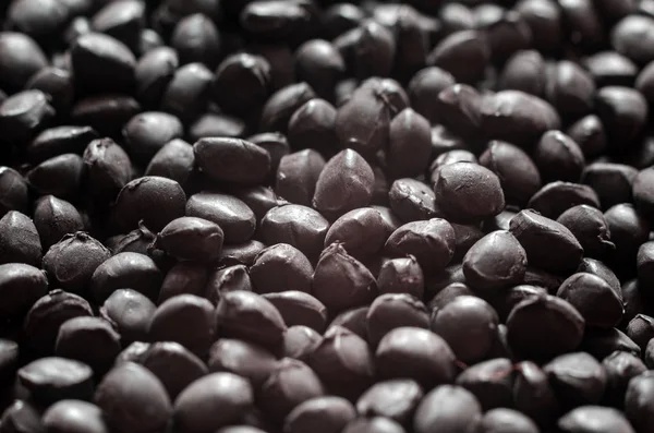 Black polymer dye in granules, background texture — Stock Photo, Image